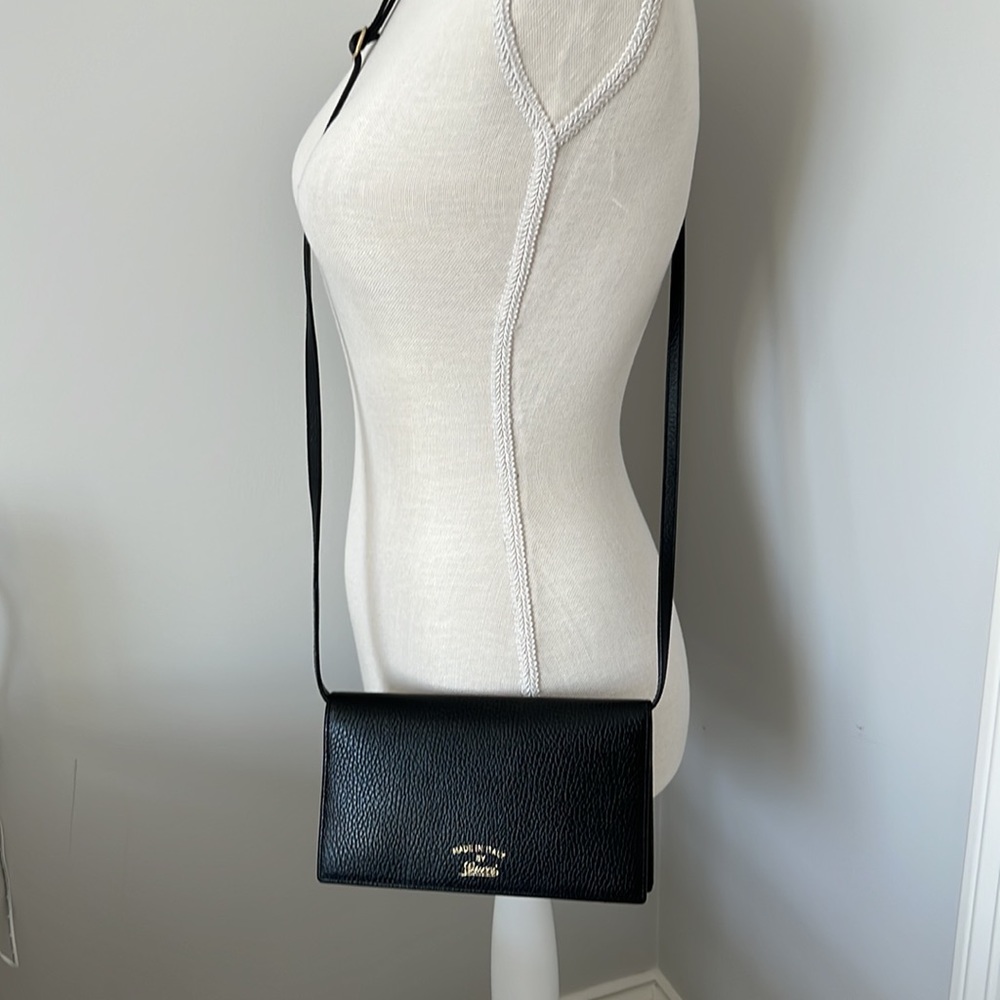 Gucci wallet with 22” adjustable and removable strap. Original dust bag & box.